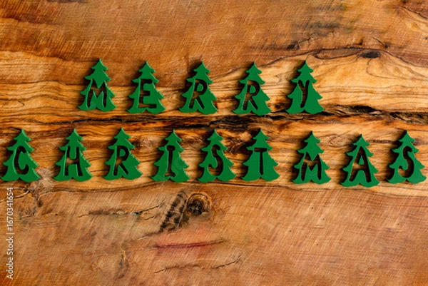 Obraz Christmas greeting with tree-shaped letters on wooden background