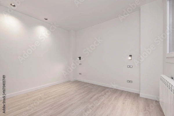 Fototapeta Light wood flooring in an empty room, where the echo highlights the purity of the architectural lines