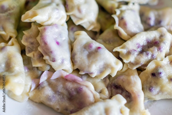Obraz Plate of dumplings with forest bilberry filling called in Poland as pierogi