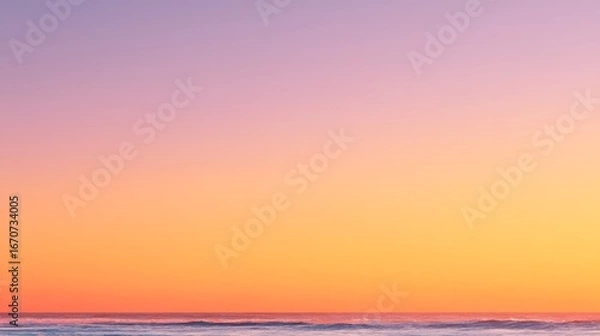 Fototapeta A serene, pastel sunset over a calm ocean, showcasing a soft color gradient from lavender to orange.
