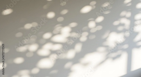 Obraz Gentle dappled sunlight patterns from leaves cast soft shadows on a clean textured wall creating a peaceful and tranquil atmosphere with natural light	
