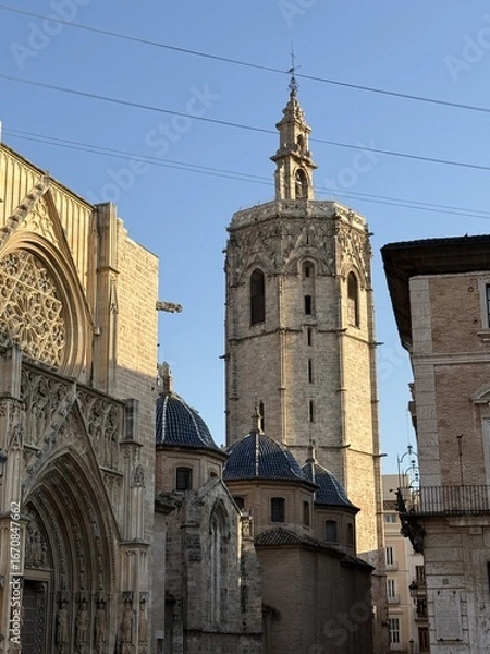 Obraz Central square in the historic center of Valencia, Spain. Gothic Valencia Cathedral against blue sky on a sunny day in Plaza de la Virgen