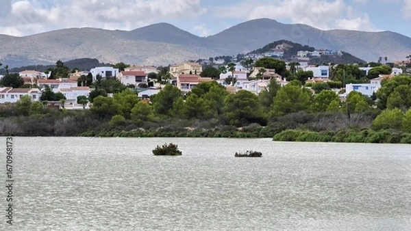 Fototapeta Enjoy a stunning lake view surrounded by majestic mountains and charming houses