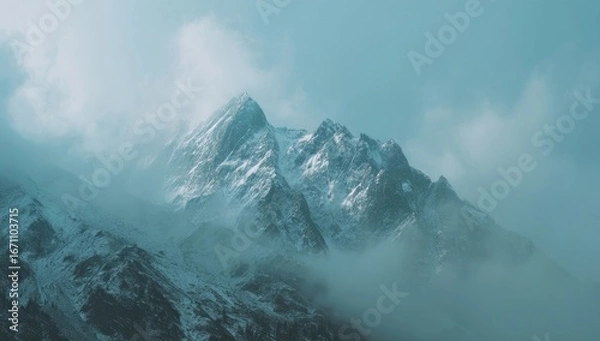 Fototapeta Misty mountain peak, snow-capped