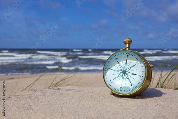 Obraz antique brass nautical compass on the beach