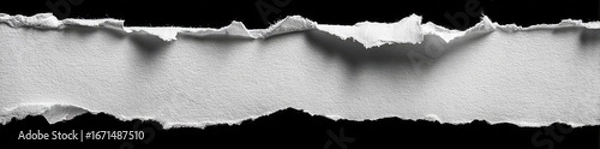 Fototapeta Ripped piece of white paper on a black background (1)