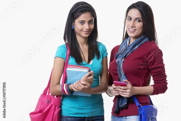 Fototapeta Portrait of beautiful college students with books and bags against white background