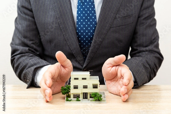 Obraz 家の模型とビジネスマン