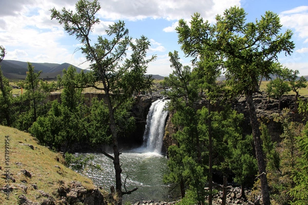 Fototapeta The Orkhon Waterfall is located in Mongolia. A small lake has formed where the waterfall, the source of the Orkhon River, flows into the water.