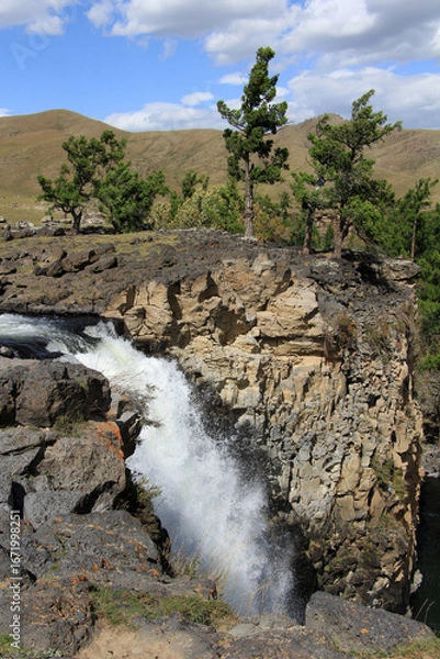 Fototapeta The Orkhon Waterfall is located in Mongolia. A small lake has formed where the waterfall, the source of the Orkhon River, flows into the water.
