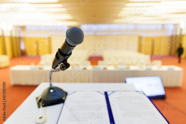 Fototapeta Microphone and Documents on a Podium in an Empty Conference Hall