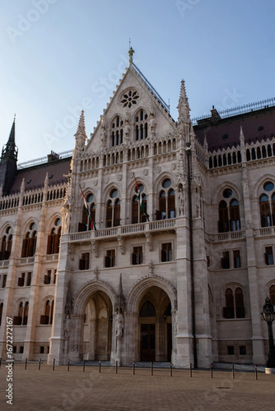 Obraz Detail of the main facade of the Hungarian Parliament, one of Budapest's most famous buildings. The sunset light enhances the complex Gothic Revival architecture.