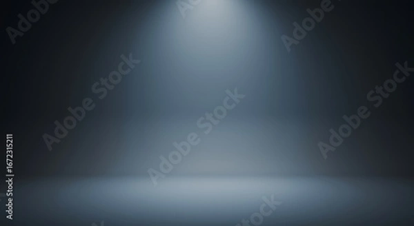 Obraz Spotlight shines down onto an empty stage or studio space with a dark blue gradient background.