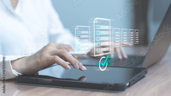 Fototapeta Woman interacting with laptop showing virtual database icons and green check mark symbolizing cloud data validation and access.
