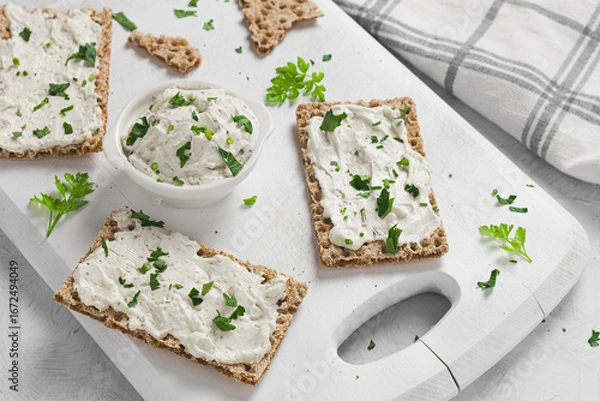 Obraz Crispbread toast with Cottage Cheese and parsley on white wooden board.