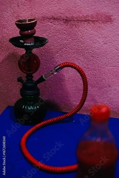 Fototapeta Hookah on a table with blue table and pink wall background