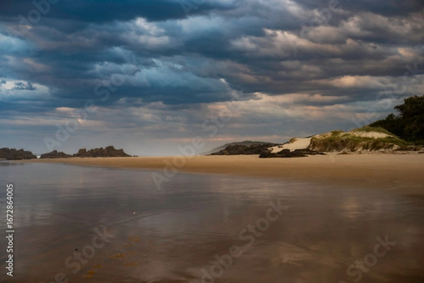 Fototapeta Sunset over Delicate Nobby Beach