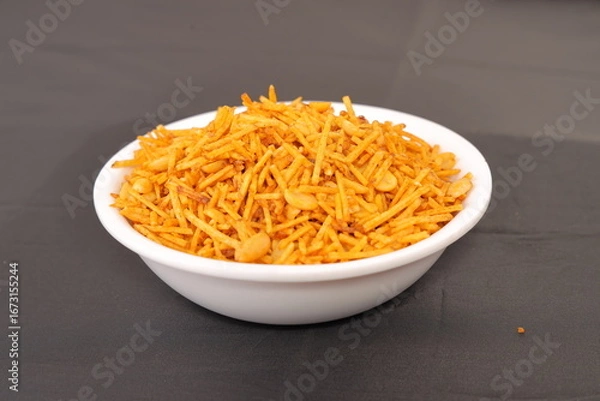 Fototapeta Indian snacks called Upwas Chivda or Upwas Special made fron Potatoes crispy and spicy serve on bowl isolated