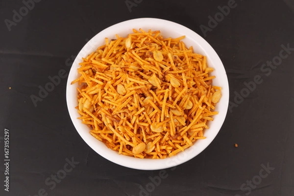 Fototapeta Indian snacks called Upwas Chivda or Upwas Special made fron Potatoes crispy and spicy serve on bowl isolated