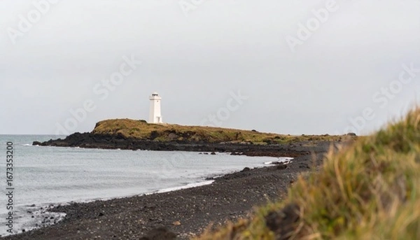 Fototapeta Minimal coastal scene — a small white lighthouse sharply rendered on a distant headland; expansive calm sea-to-sky gradient providing 60–70% copy space; cool airy palette, gentle vignetting; 135 mm on