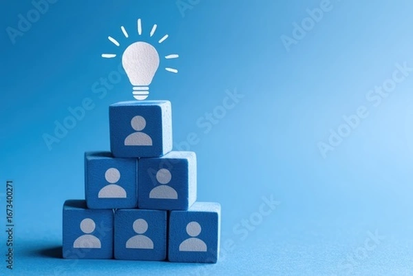 Fototapeta Lightbulb atop a pyramid of light-blue blocks with person icons, on a bright-blue background
