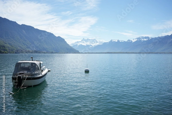 Fototapeta boat on the lake with snowy mountains