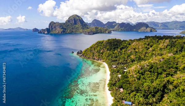Fototapeta Aerial photography over the sea coast with towering limestone cliffs, stunning turquoise-blue lagoons, and pristine white sandy beaches