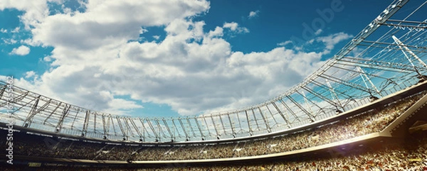 Obraz crowded soccer stadium with tribunes on blue cloudy sky background