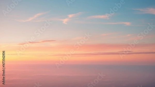 Fototapeta Sunset sky with soft pink and blue clouds over the horizon. Peaceful scene, beautiful sky colors.