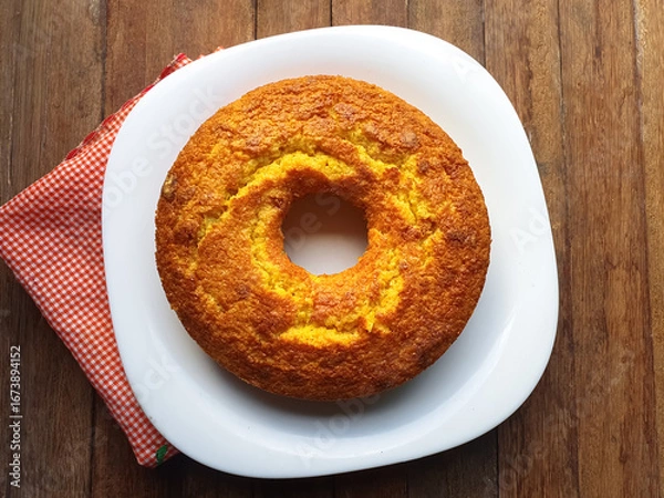 Fototapeta simple cornmeal and corn cake on a wooden background seen from above
