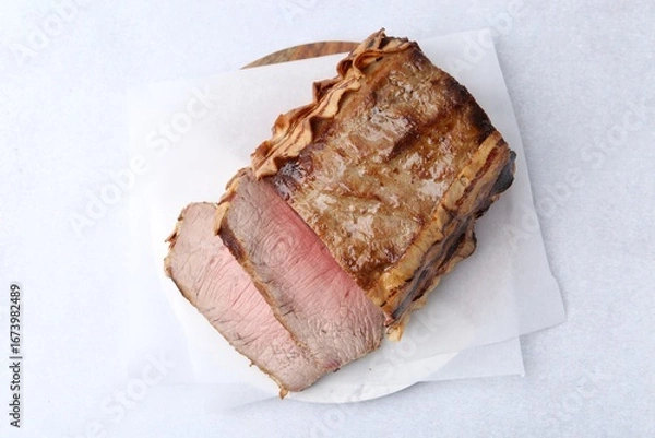 Obraz Delicious baked beef meat on light table, top view