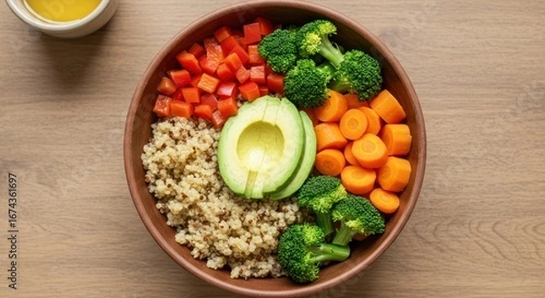 Fototapeta Healthy Vegetarian Meal with Quinoa Avocado Broccoli Carrots and Red Peppers in Wooden Bowl