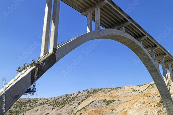 Fototapeta Renewing corrosion damages on arch and pillars of concrete bridge Maslenica on A1 highway in Croatia