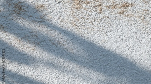 Fototapeta Textured surface with light and shadow patterns on rough stone.