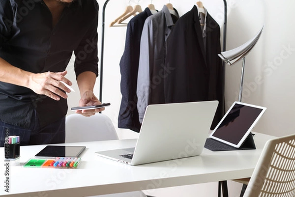 Fototapeta Businessman working with laptop and smartphone in modern office