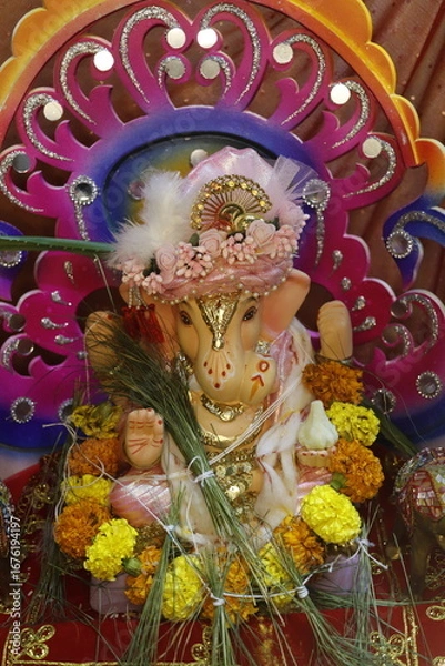 Fototapeta Ganapati festival celebration at home with a beautifully decorated Ganesh idol, flowers, lights, and traditional offerings, symbolizing devotion, prosperity, and cultural heritage in a festive atmosph