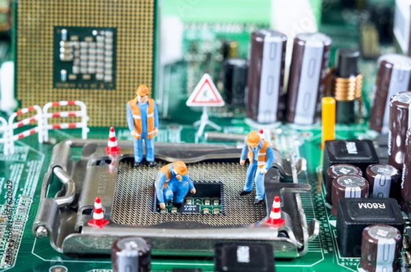 Fototapeta Toy technicians are repairing or diagnosing a motherboard. Under Construction concept. Selective focus.