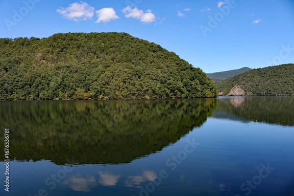 Obraz mountain reflection on a lake with blue sky and clouds
