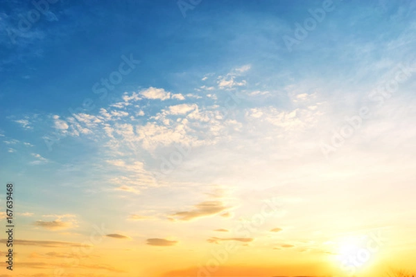 Fototapeta Sky background at sunset,Sky blue and orange light of the sun through the clouds in the sky