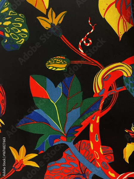 Obraz Colorful tropical fabric with abstract leaves, flowers, and bold patterns on black background. Exotic textile design with red, yellow, green, and blue elements, perfect for fashion, decor, or prints.