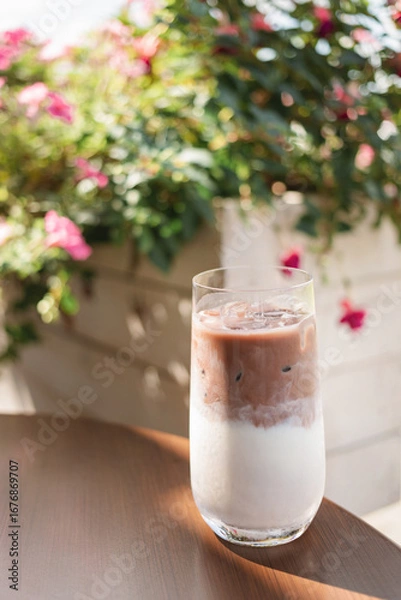 Fototapeta Close-up of an iced mocha coffee on a table at a street cafe in summer.