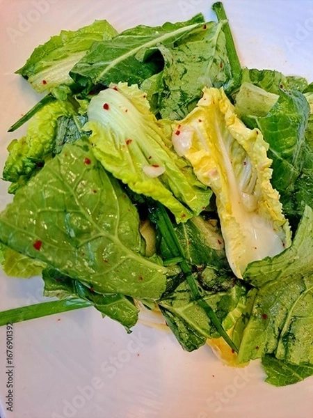 Fototapeta Fresh Kimchi Geotjeori - This Korean food Kimchi can be compared to an uncooked salad rather than a fermented dish. The salted cabbage is mixed with various seasonings and eaten on the spot