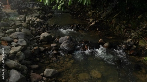 Fototapeta Scenic river with flowing water, rocks, trees, underwater view and sun reflection