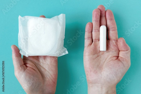 Obraz Feminine sanitary pad and tampon for intimate hygiene in Caucasian woman's packaging. Turquoise background.