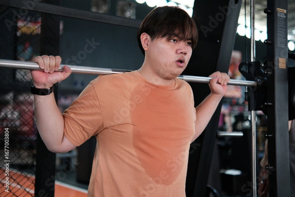 Fototapeta Overweight Man Doing Squats with Barbell at Gym. Strength Training and Sweat Effort