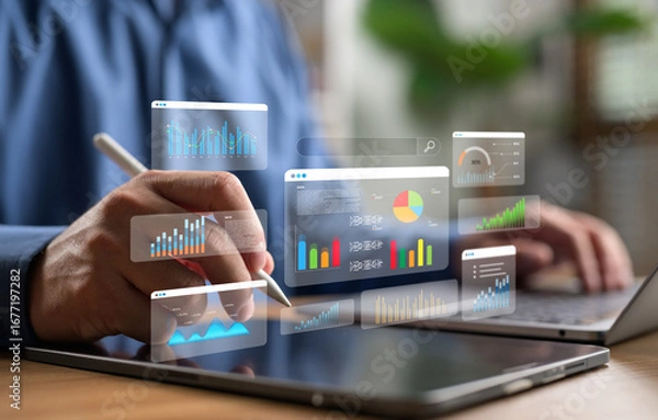 Fototapeta Businessman analyzing data on digital tablet with futuristic graphs and charts. Concept of big data, digital marketing, financial analytics and business intelligence.