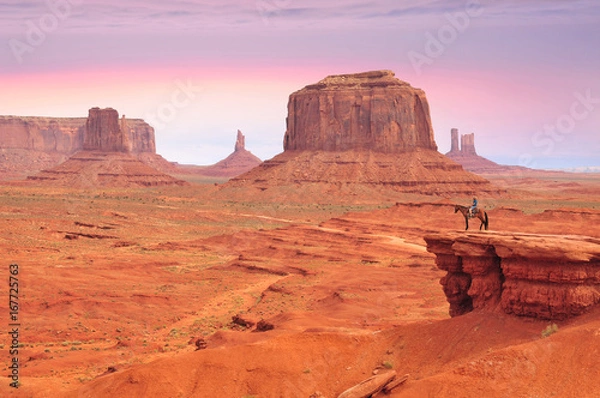 Fototapeta Man on a horse, view from John Ford's Point in Monument Valley with the West Mitten Butte and the Merrick Butte in Utah-Arizona border, United States of America.