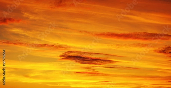 Obraz Photo of orange sunset with dark clouds on sky