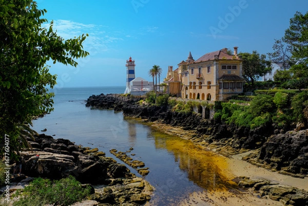 Fototapeta Lighthouse Museum of Santa Marta in Cascais Portugal, as seen from Santa Marta Beach on a beautiful day. Cascais, Portugal