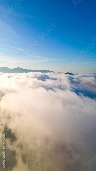 Obraz High-altitude view of clouds over mountains